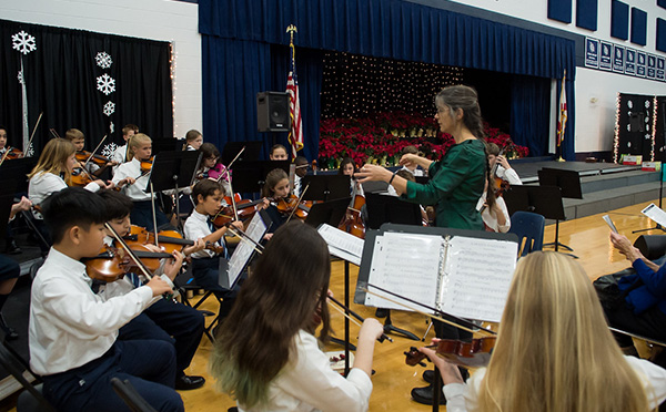 Students playing instruments in orchestra