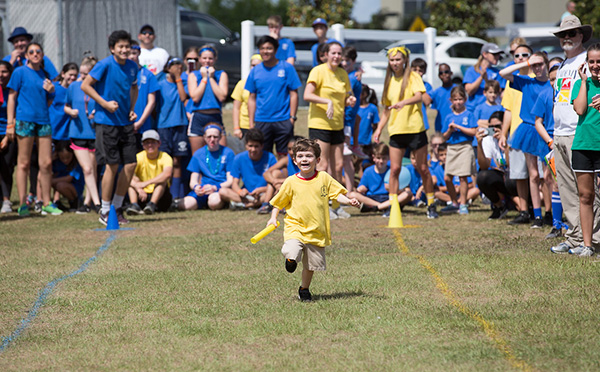 Young boy running a relay race